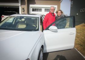 Two people standing by a car