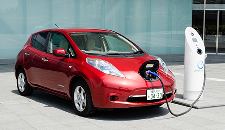 red preowned eco friendly vehicle that is parked at a charging station11 10